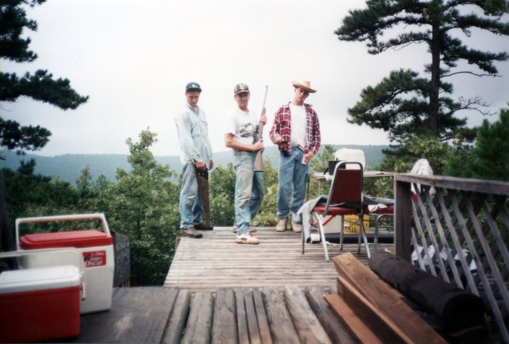 The Author, his brother and friend standing on the deck of the remote cabin in Oklahoma. 