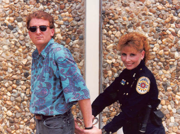 The Author, Daniel Wolfert acting the part of a criminal being arrested by a female police officer. 