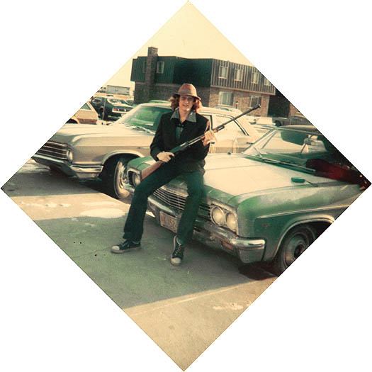 The Author sitting on the hood of his car with a shotgun circa 1977.