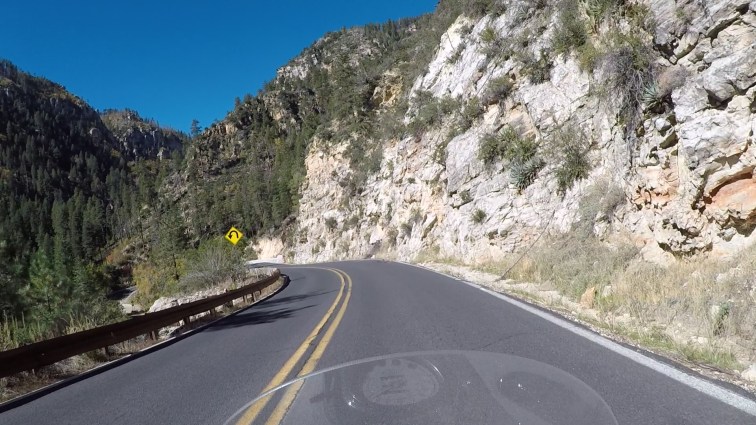 POV riding a motorcycle in Oak Creek Canyon.