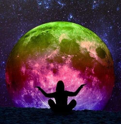 An image of a woman watching a huge multi-colored moonrise. 