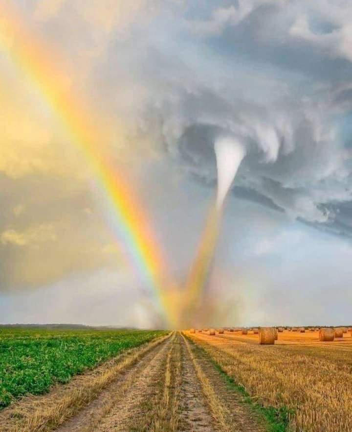 A depiction of a tornado side by side with a rainbow. 
