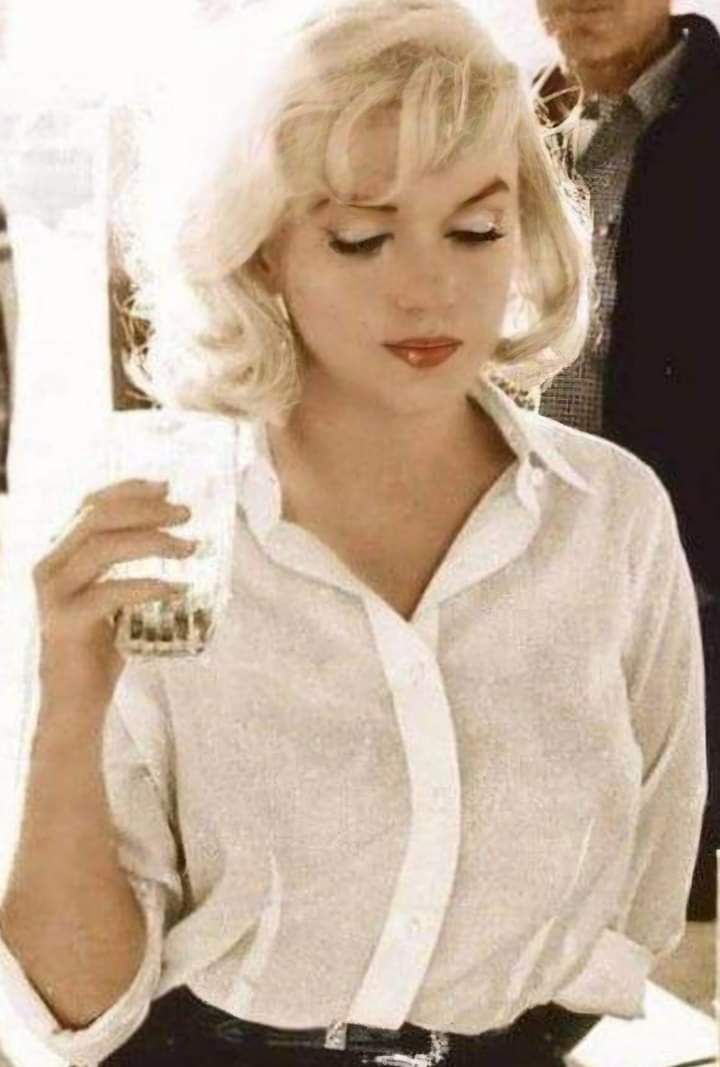A photograph of Marilyn Monroe with a drink in her hand- circa 1969.