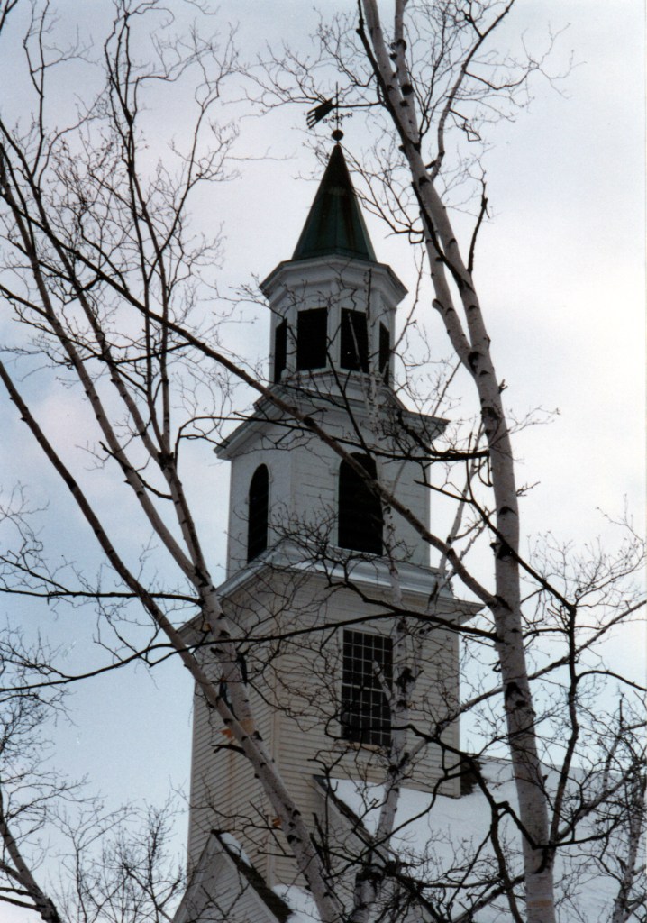 An image of a church steeple in winter,
